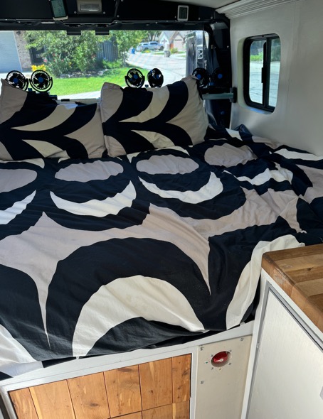 Custom queen size bed in back of camper van